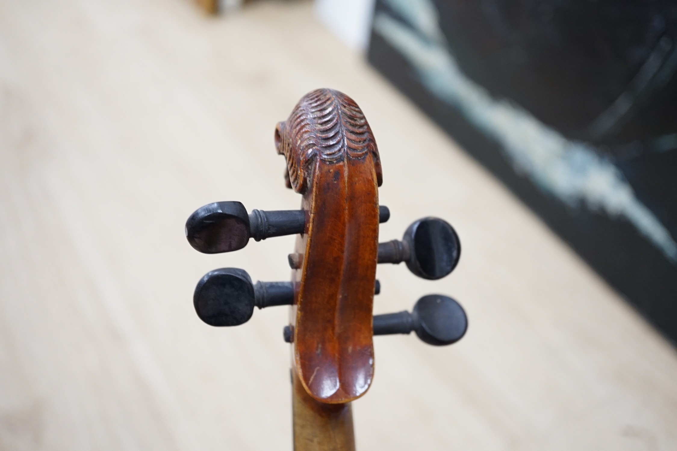 A late 19th century lion head violin and case